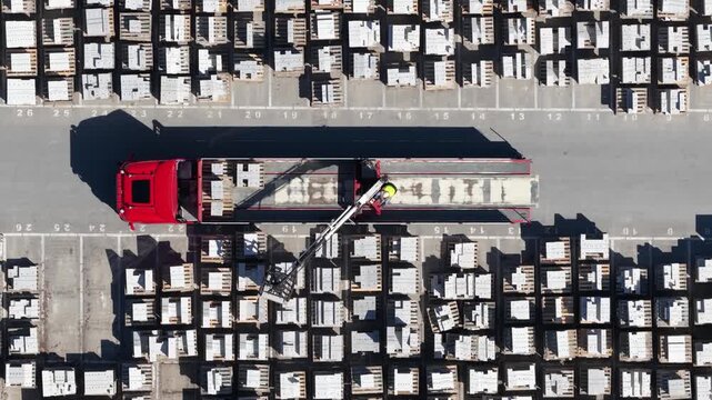 Aerial top view of truck loading building materials in a warehouse