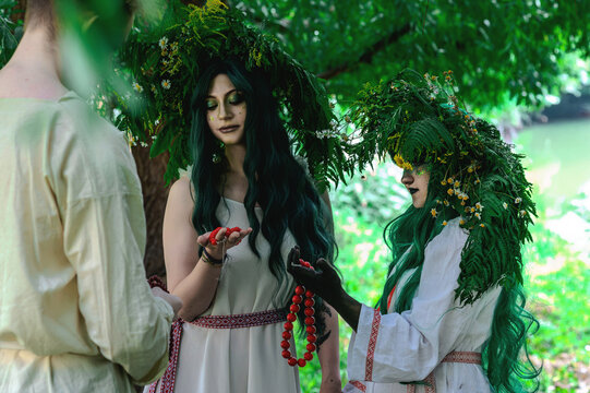 Rusalka in white with a wreath on her head and green hair