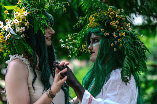 Rusalka in white with a wreath on her head and green hair