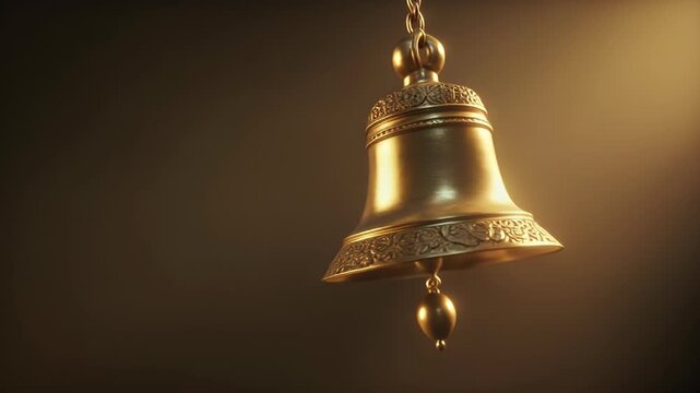 A shiny golden bell hangs from a chain against a dark background.