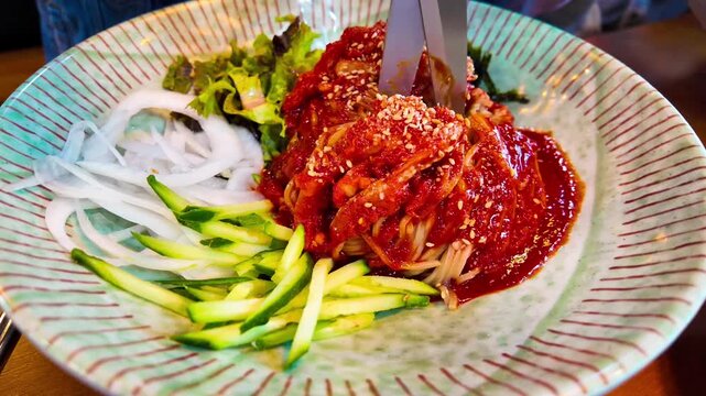 Makguksu cut with a scissors, a traditional and popular noodle dish enjoyed especially in summer in Korea