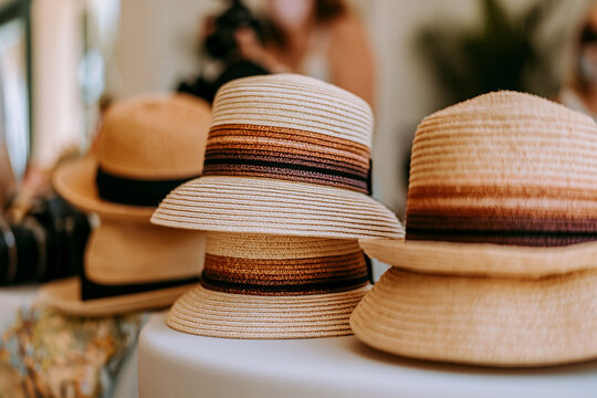 Collection of stylish straw hats in boutique display