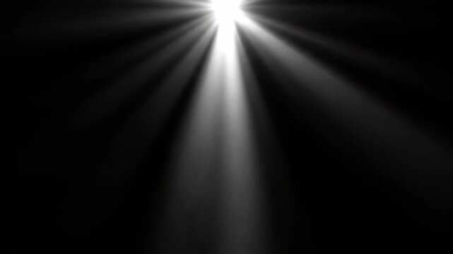 Bright light illuminating downward with rays, abstract dark background