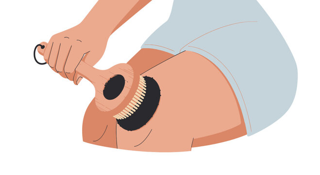 Woman dry brushing her thigh with a natural bristle brush for exfoliation and circulation
