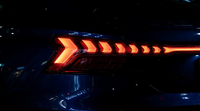 Illuminated car taillight at night, modern automotive lighting design