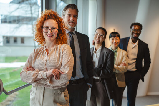 Diverse professional business team smiling standing in office