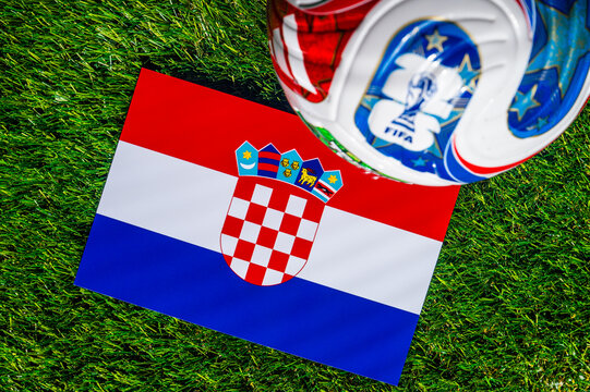 ATLANTA, USA, APRIL 21, 2026: Croatia National Flag Checkerboard with Official FIFA 2026 Match Ball on Grass. World Cup Background.