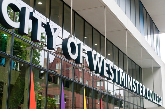 City of Westminster College main entrance sign mounted above modern glass building facade in Paddington London