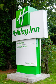 Modern green and white Holiday Inn hotel signage totem in Washington, Tyne and Wear, United Kingdom