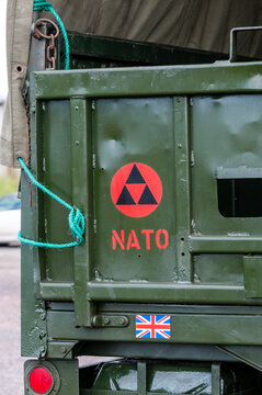 NATO symbol displayed on the rear tailgate of a British Army logistics lorry parked at a military base, highlighting defence infrastructure and international cooperation.