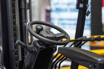Close up of steering wheel inside forklift cabin © Dong