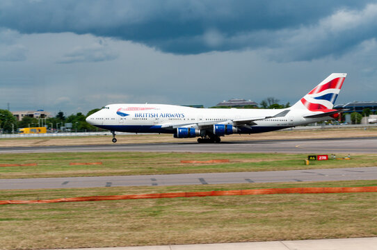 A British Airways Boeing 747 makes a majestic landing on the tarmac at London Heathrow Airport, its massive frame and extended landing gear capturing the scale and power of long-haul international tra
