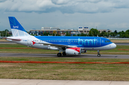 The BMI A319 aircraft taxis along the runway preparing for departure. Known for being acquired by British Airways in 2012, this image captures a significant piece of aviation history in operation.