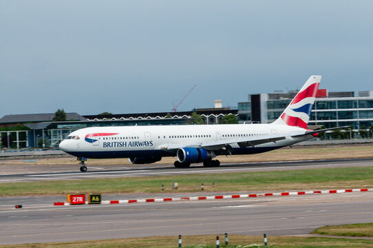 A British Airways Boeing 757 airliner performs a smooth landing, its wheels making firm contact with the Heathrow Airport runway as the iconic aircraft concludes its journey at the busy London hub.