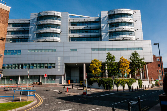 The twelve-storey critical care block at Belfast's Royal Victoria Hospital, featuring a striking glass facade and polished ceramic panels, designed to house advanced theatres and intensive care wards.