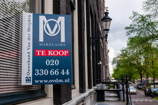 "Te Koop" (For Sale) estate agent sign on a house in an Amsterdam street.