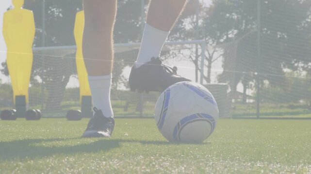 Football player nudging ball and practicing close control feint and sole roll prepping pass to goal