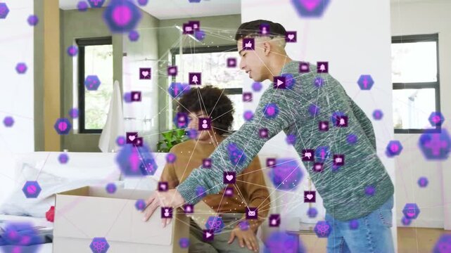Man entering carrying box moving in pal sorting clothes as purple tech overlay drifting around them