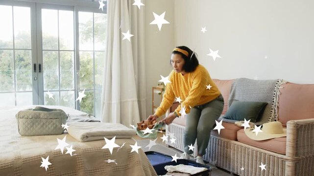Woman preparing for travel, packing suitcase then calling on smartphone, star overlay appearing