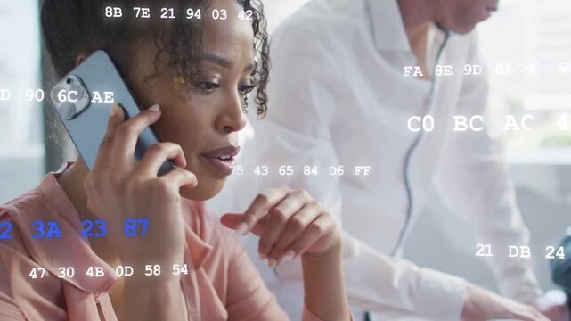 Woman receiving call, coordinating tech and typing as animated code drifting over face and keyboard