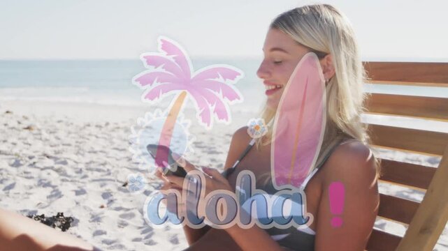 Woman sitting on beach lounge tapping phone and laughing while aloha overlay appearing for travel
