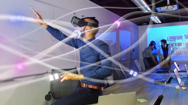 Man wearing VR headset raising hands in meeting, touching glowing data nodes during business demo