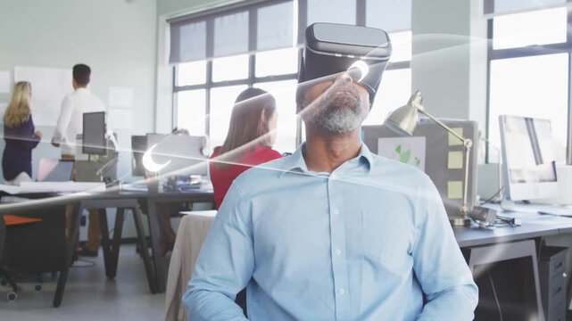 Seated man wearing VR headset following animated light sweeping across headset for business demo