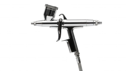 Naklejka premium A chrome airbrush tool with a top-mounted paint cup, isolated against a solid black background, showing metallic reflections and a trigger