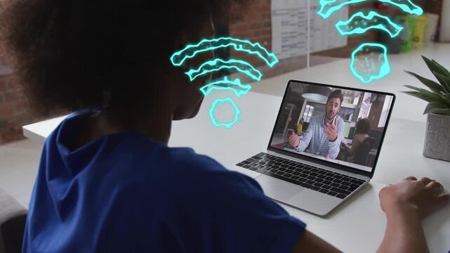 Woman watching laptop as speaker speaking, animating teal network icons around both for tech collab