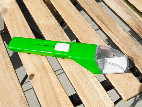 Green insect and spider catcher with a transparent capture section, presenting a simple solution for safe insect handling.