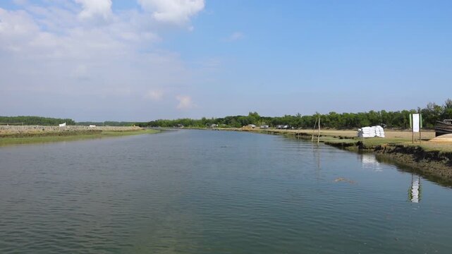 The horizon, seen from a tourist boat on the way to Char Kukri Mukri Island, is blue sky and mangrove forests on both sides.
