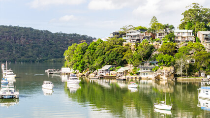 Fototapeta premium Scenic Mooney Mooney Wharf View with Boat Reflections on the Hawkesbury River