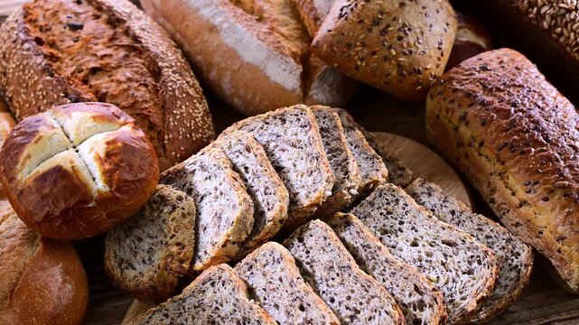 Assorted bakery products including loaves of bread and rolls.