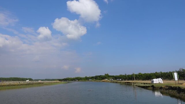 The horizon, seen from a tourist boat on the way to Char Kukri Mukri Island, is blue sky and mangrove forests on both sides.