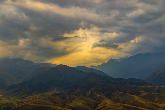 Dramatic Mountain Landscape with Stormy Sky and Golden Light