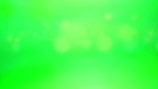 Bokeh animation of light with chromatic dust fragments on a green screen 