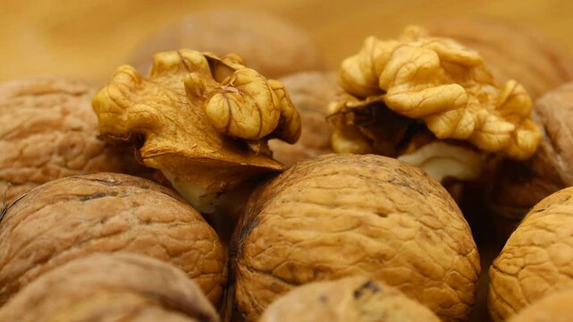 Close-up of whole and shelled walnuts background. Ideal for food, healthy eating, cooking, or natural ingredient related projects.