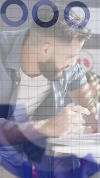 Vertical video: Data overlay appearing, man writing notebook with green pencil guiding kid learning