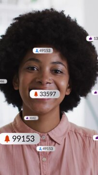 Vertical video: Woman smiling bell popping causing social badges piling around face showing growth