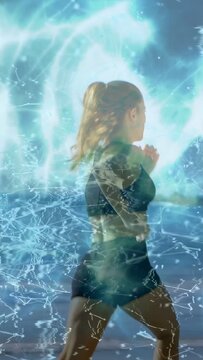 Vertical video: Female runner starting run by sea, causing teal glow and node web tracking fitness