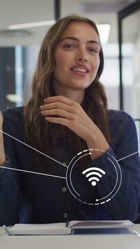 Vertical video: Woman speaking to camera and causing WiFi HUD while gesturing, waving, demoing tech