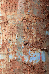 Fototapeta premium Rusty Blue Metal Surface - Peeling Paint and Corrosion Texture. The reddish‑brown rust contrasts with the remaining blue color, creating a dramatic, weathered texture full of detail and character. 