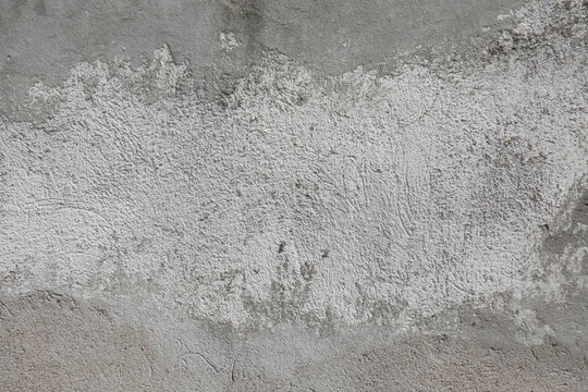 Rough gray and white concrete surface texture with natural pores, cracks, speckles, and subtle imperfections. Ideal for architectural backgrounds, construction materials, industrial design reference.