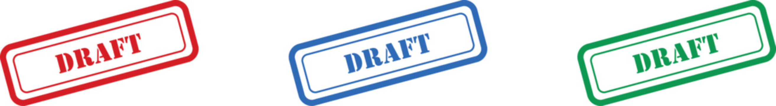 Three colorful draft text stamps in red blue and green indicating work in progress on a white surface
