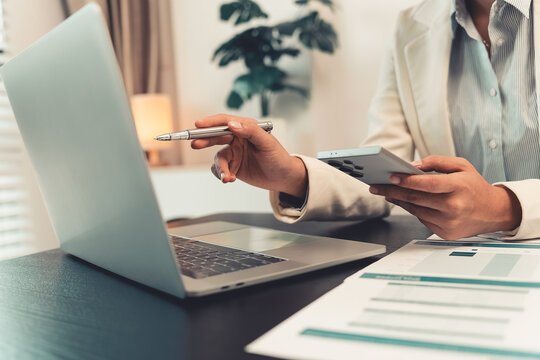Business professionals are discussing charts and graphs that display successful results in order to analyze financial reports, plan strategies, and improve efficiency.
