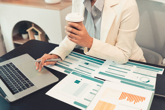 Business professionals are discussing charts and graphs that display successful results in order to analyze financial reports, plan strategies, and improve efficiency.