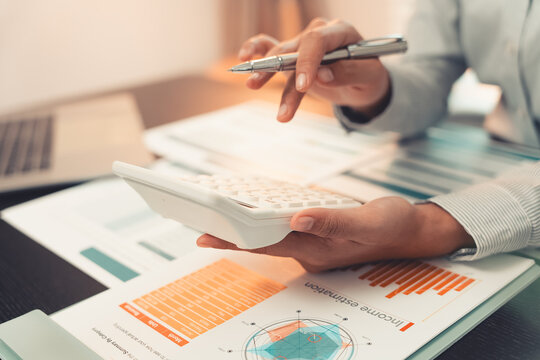 Business professionals are discussing charts and graphs that display successful results in order to analyze financial reports, plan strategies, and improve efficiency.