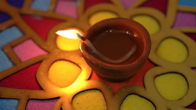 Decorative rangoli plate adorned with glowing diyas, vibrant patterns, and traditional designs, capturing the festive spirit of Diwali celebration in India.