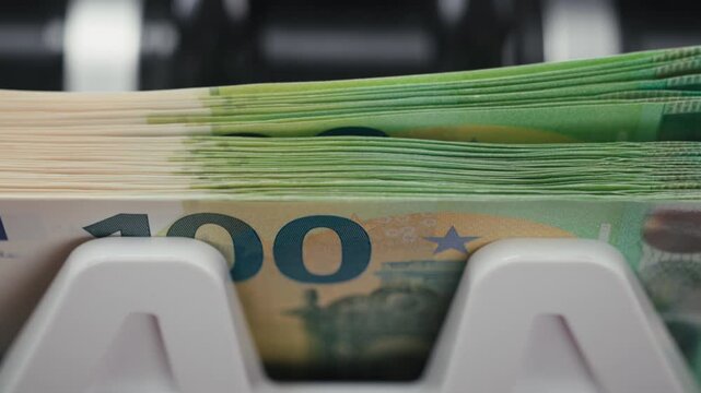 Money counting machine rapidly handling euro cash in modern business environment. Concept corporate finance and operational efficiency.
