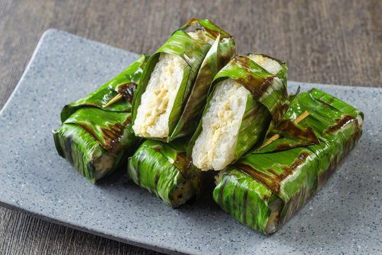 Lemper Ayam bakar, Indonesian Traditional snack of savory steamed glutinous sticky rice filled with seasoned shredded chicken, wrapped and grilled in banana leaves